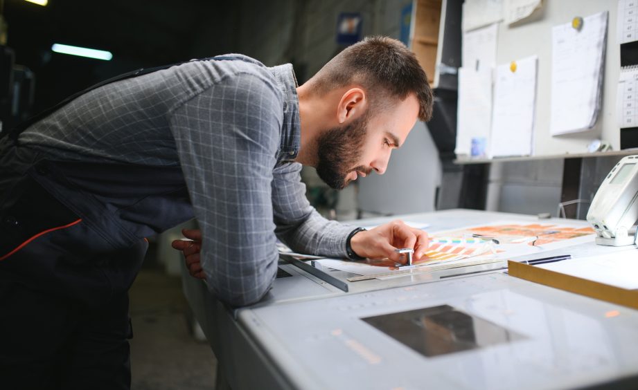 Printing house interior with modern offset print machine